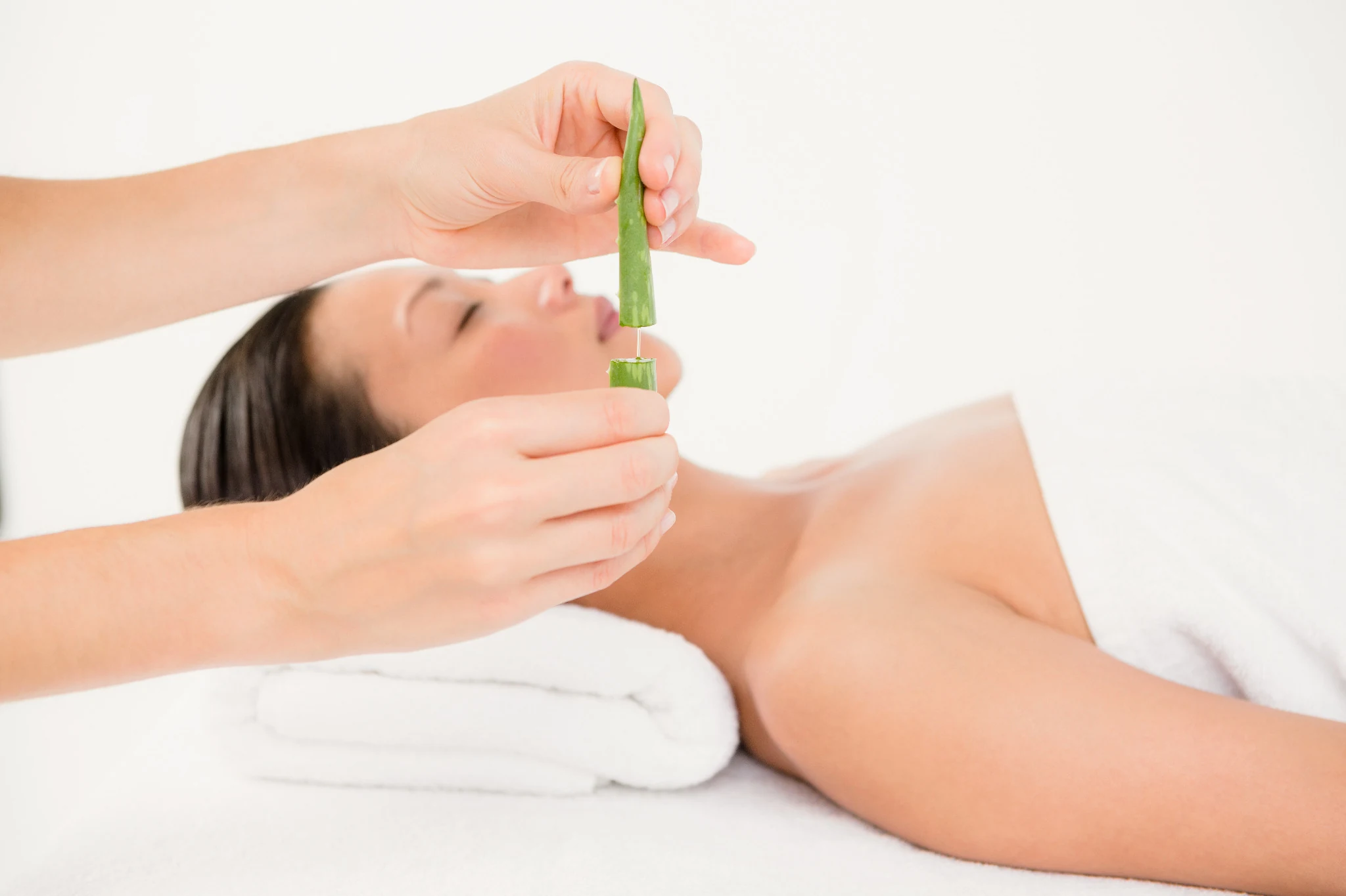 Applying soothing aloe gel to facial skin after laser treatment
